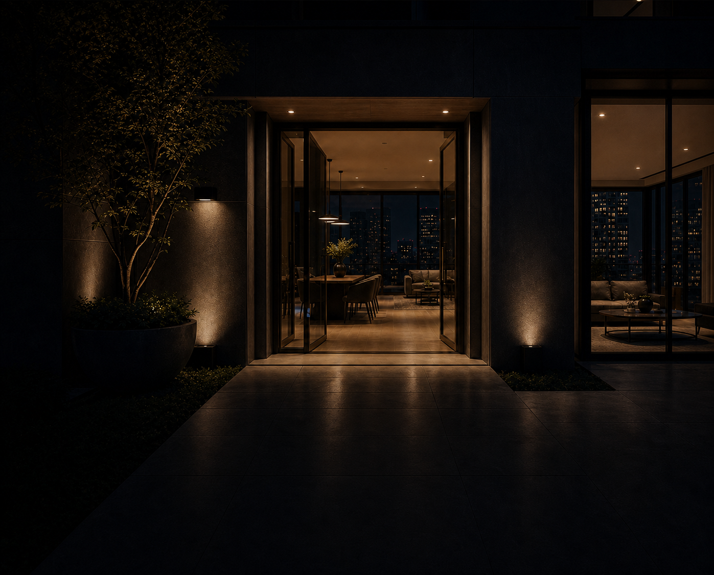 Illuminated entrance to a Malabie smart apartment at night